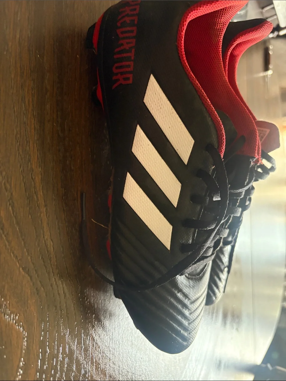 adidas Men’s Black Soccer Shoes with Red Lining and White Stripes